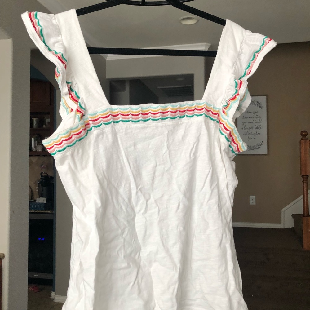 Cute tank with multi-colored embroidered stripes.